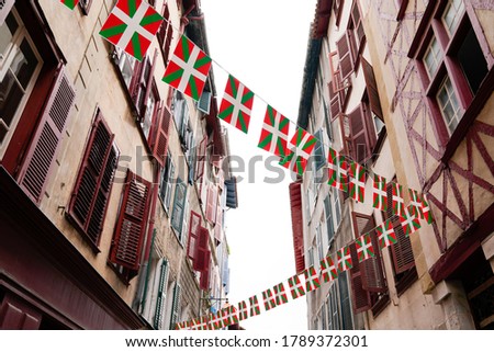 bask flag on facades of old houses basque in Bayonne France 