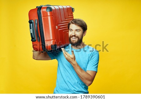 suitcase in hand happy traveler laughing yellow background 