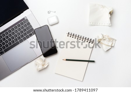Planning at work. Strategy planning. Business development concept. Set the goals. Laptop, notebook, airpods, phone and pencil on white office desk top view 