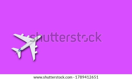 Plane on purple  background with top view and copy space. Travel background for travel agency banner. Flat  lay 