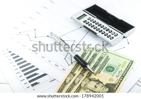 stock graph report with calculator, pen and usd money for business