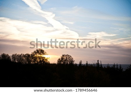 Sunset with clouds and trees