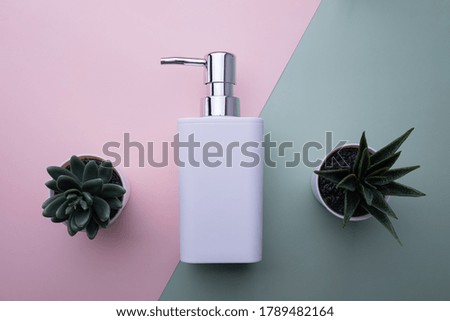 natural cosmetics bottle containers on color paper background, beauty product concept 
