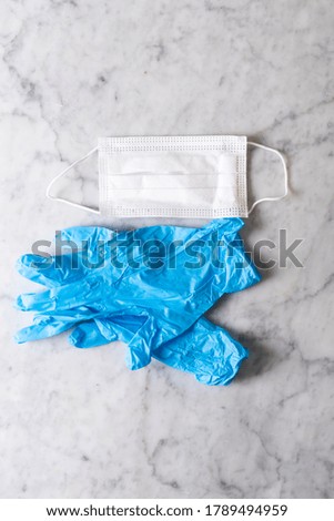 Medical mask and gloves on a light background