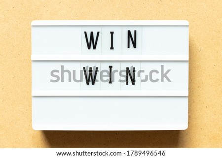 Lightbox with word win win on wood background