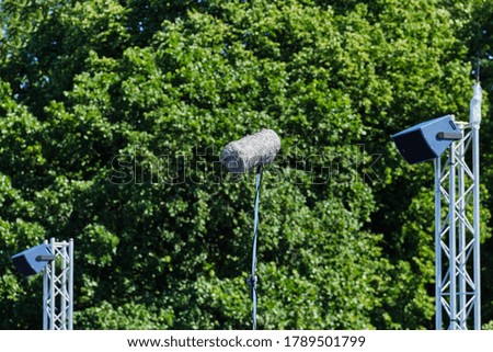 Professional windproof microphone with green trees background