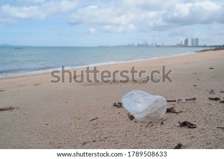                                Spilled garbage on the beaches of big cities  Empty plastic used, dirty, environmental pollution  Ecological problems  Moving waves in the background