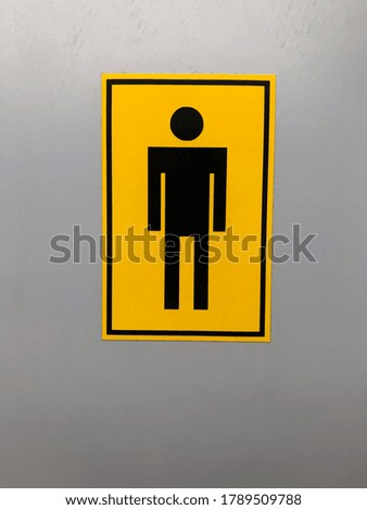 symbol of a man on a toilet door, yellow sign