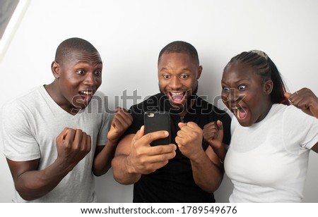 africans celebrating after winning and looking into the contents of their phones