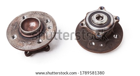 Wheel hub with bearing from old metal close-up on white isolated background in a photo studio. Seasonal repair of the suspension and braking system in the workshop or spare parts for sale.