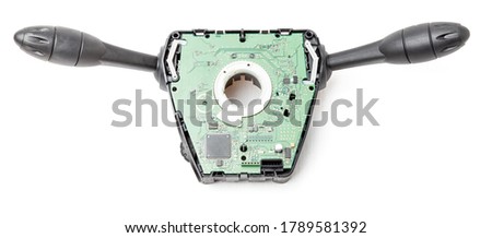 Steering wheel switches for windshield wipers and turn signals disassembled on a white isolated background in a photographic studio, spare part for car repair or for sale at junk yard.
