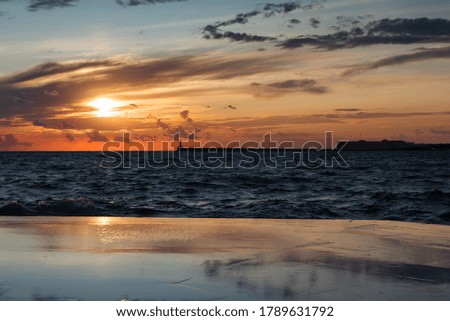 Beautiful sunset on the embankment of Sevastopol (Crimea). The sun sets in the sea. Very beautiful seascape, view of the sea, waves and sky with clouds.