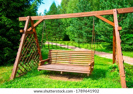 wooden swings in the garden as a place to relax