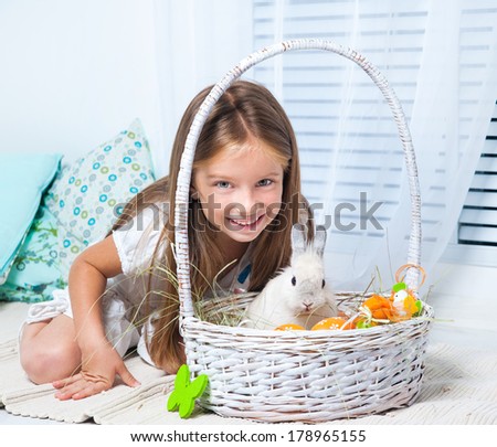 Easter photo. cute happy little girl and rabbit