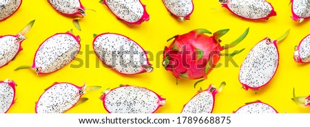 Ripe dragonfruit or pitahaya slices on yellow background. Top view