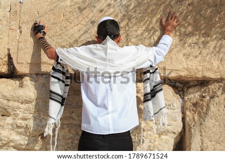 A 13-year-old teenager prays at the western wall. Bar mitzvah ritual Royalty-Free Stock Photo #1789671524
