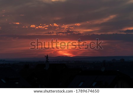 late sunset sky with clouds over the city Royalty-Free Stock Photo #1789674650