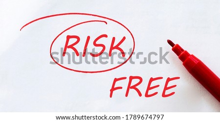 white paper with text Risk Free on the white with red marker
