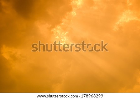 Rays of light shining through dark clouds for background