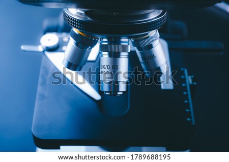 Laboratory equipment optical microscope, closeup of scientific microscope with metal lens, data analysis in the laboratory Royalty-Free Stock Photo #1789688195