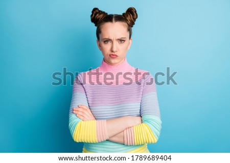 Photo of attractive teen lady two funny buns bed mood arms crossed moody negative misunderstanding offended boyfriend wear casual striped sweater isolated blue color background Royalty-Free Stock Photo #1789689404