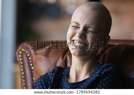 Close up of happy young sick woman suffering from cancer laugh smile feel positive optimistic about future recovery, overjoyed millennial ill female patient with oncology show high spirit optimism Royalty-Free Stock Photo #1789694282