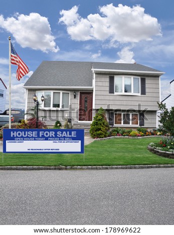 Flag Pole Real Estate For Sale Welcome Open House sign Suburban Cape Code style home with Dormer residential neighborhood USA blue Sky clouds