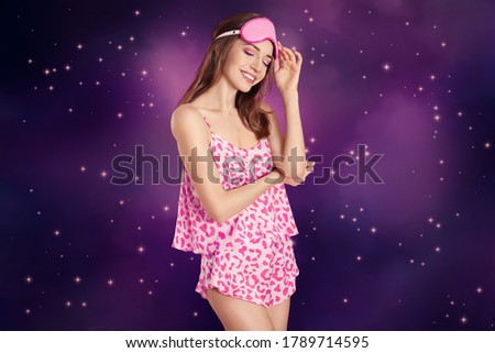 Beautiful woman and night starry sky on background. Bedtime