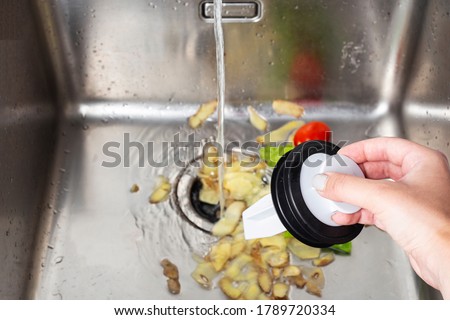 vegetable waste in the kitchen sink, garbage shredder,food waste Royalty-Free Stock Photo #1789720334