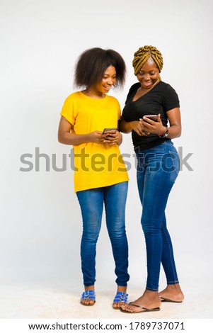 Young beautiful black ladies checking out something interesting on a smart phone