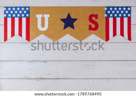 Celebrating US. federal holiday with US word of letters in the America flag on old wood background