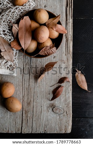 Sapodilla fruit / chikoo on wooden background
