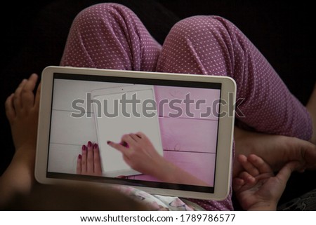 a girl with a tablet in her hands