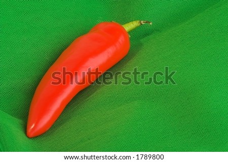 red chilli pepper on green background
