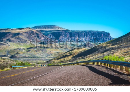 A road winds through the Davis Mountains in west Texas. Royalty-Free Stock Photo #1789800005