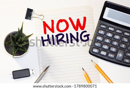 Now hiring written on a white piece of paper on wooden background. illustration design
