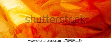 Background texture, orange silk fabric with painted meadow flowers