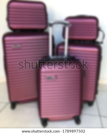 Blurred view of packed travel suitcase, airport. Summer holiday and vacation concept. Traveler baggage,  luggage in empty hall interior. Copy space.
