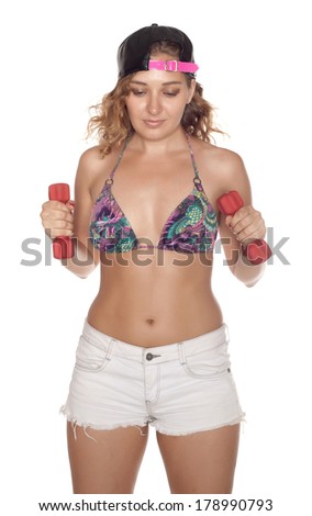 Woman doing exercises with dumbbells in studio