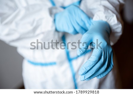 Doctor or healthcare worker wearing nitrile gloves Royalty-Free Stock Photo #1789929818