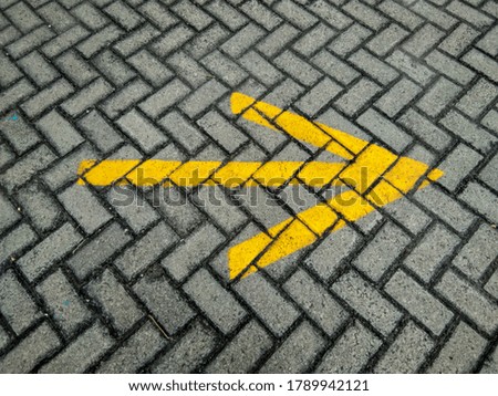 paving sign yellow arrow grey