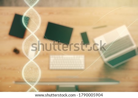 Creative DNA sketch on modern laptop background, biotechnology and genetic concept. Multiexposure