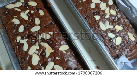 Chocolate fudge brownies with shiny crust, unfocused picture, blurry background, noise and grain texture, reflected by light