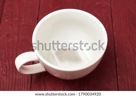 Tea bag in a white cup. Preparation for making tea.