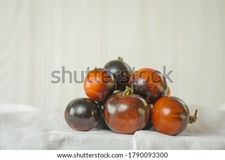 Organic fresh juicy tomatoes Golden Crabapple . Tomatoes with leafs. Ripe tomatoes on white background.