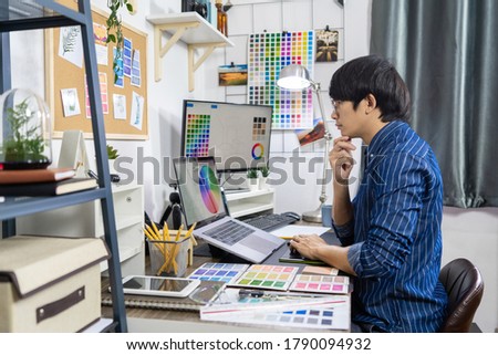 Asian Designer or creative Occupation Design Studio artist working on graphic computer at the office using graphics tablet and a stylus, Illustrator Graphic Skill Concept