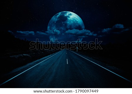 Open road of night sky with clouds and moonlight. Elements of this image furnished by NASA. Royalty-Free Stock Photo #1790097449