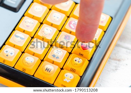 A finger presses a button with a heart sign on the keyboard. Close up. Concept of social networks, communication and emotions