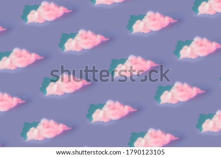 Pattern made of clouds of cotton wool in holographic neoon colors on pastel purple background. Cyberpunk aesthetic concept art. Minimal surrealism. Royalty-Free Stock Photo #1790123105
