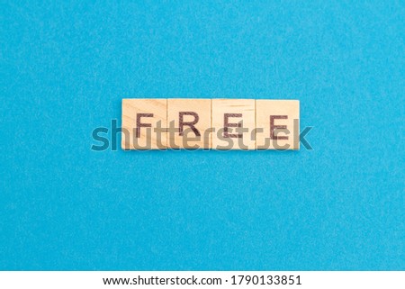 FREE word from wooden blocks on a blue background